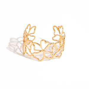 Gold open cuff bracelet with irregular hollow floral design, retro metallic fashion jewelry.
