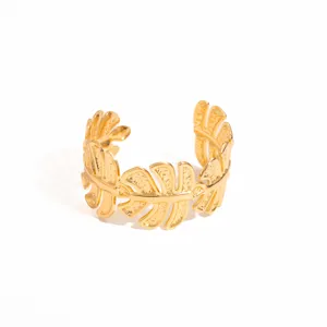 Gold leaf cuff bracelet detail, textured metal open bangle, statement geometric wrist jewelry.