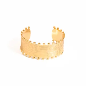 Exquisite gold open cuff bracelet with unique textured design for chic retro style.