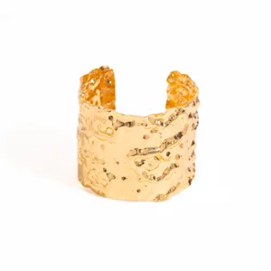 Close-up view of the wide gold irregular textured open cuff bracelet showing retro metal details.