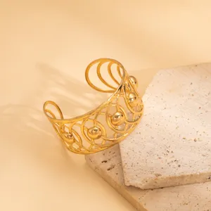 Exquisite gold-plated open cuff bracelet featuring an intricate geometric hollow design style.