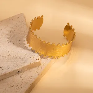 Gold wide cuff bracelet featuring delicate beaded edges and stylish vintage brushed texture detail.