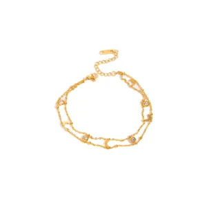 Detailed view of the double layer gold stainless steel moon and crystal charm bracelet.