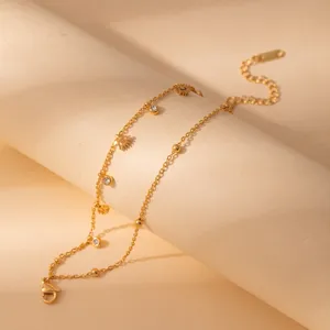 Minimalist stainless steel layered gold bracelet with crystal and flower pendants.