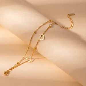 Detailed close-up of the elegant stainless steel gold-plated double-layer heart bracelet charm.