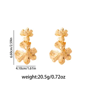 Detail shot of vintage gold hollow leaf earrings with exact size and weight specifications.