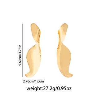 Detailed view of abstract gold metal earrings, showcasing unique geometric shape and fine texture.