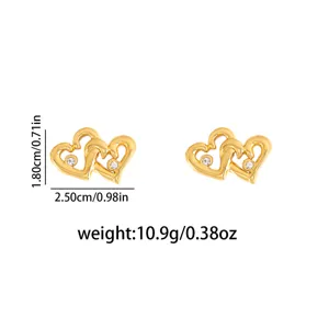 Detail view of stylish double heart metal stud earrings featuring sparkling crystal stone accents.