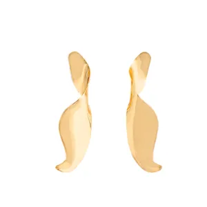 Close-up detail of the abstract gold leaf earrings showing smooth metallic finish and texture.