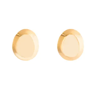 Gold metallic irregular oval stud earrings detail shot, minimalist geometric style.