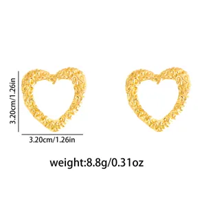 Detailed view of gold textured heart stud earrings, stainless steel geometric design.