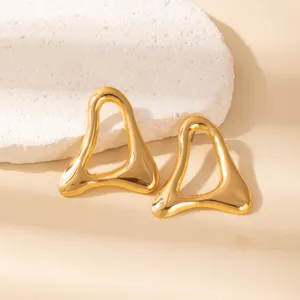 Gold geometric hollow earrings detail shot, minimalist metal abstract leaf design for modern women.