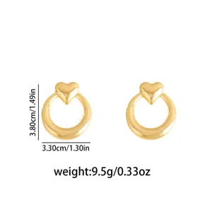 Detail view of golden stainless steel geometric heart stud earrings showing precise size and weight.