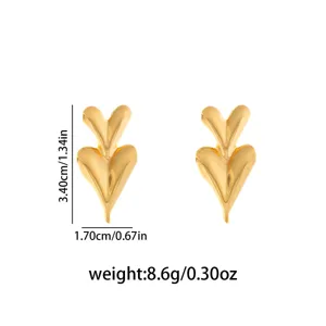 Gold double heart metal stud earrings geometric minimalist fashion jewelry accessory detail.