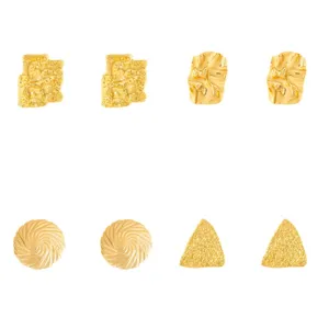Set of four unique gold metal stud earrings featuring geometric and textured abstract designs.