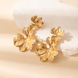 Gold metallic exaggerated leaf earrings, geometric hollow dangle earrings for women detail shot