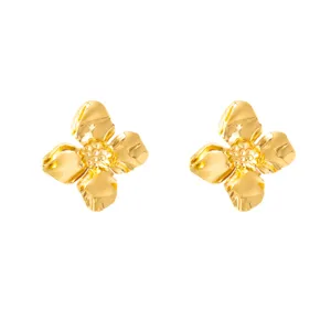 Gold metal flower stud earrings detail view, showing exquisite floral shape and shiny finish.