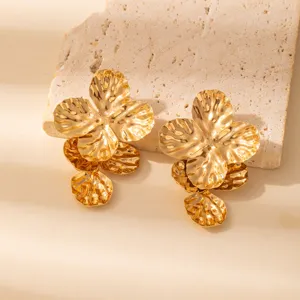 Detailed close-up of statement gold metallic multi-layered flower earrings for women chic.