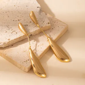 Stunning gold long leaf drop earrings, modern minimalist geometric metal jewelry for women.