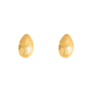 Gold abstract teardrop stud earrings, detailed view of textured metal geometric jewelry.