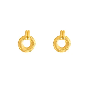 Detailed closeup of retro gold textured hoop earrings, highlighting fine metal craft and design.