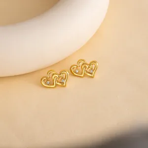 Gold-tone double heart stud earrings with sparkling crystals for elegant daily wear.