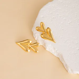 Detailed view of trendy gold geometric heart leaf stud earrings crafted with modern style.