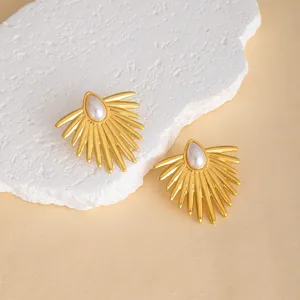 Elegant gold-tone sunburst metal earrings featuring a stylish central teardrop pearl design.