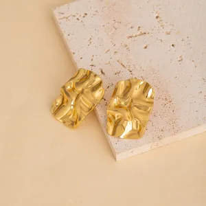 Gold irregular metal earrings detail view, minimalist geometric stainless steel ear studs design.