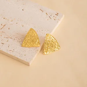 Golden textured geometric triangle stud earrings, minimalist fashion metal jewelry for women.