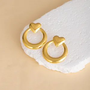 Exquisite gold heart geometric stud earrings detail, minimalist stylish metal accessory display.