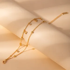 Double layer gold stainless steel bracelet with cute heart charms and sparkling crystal stones.