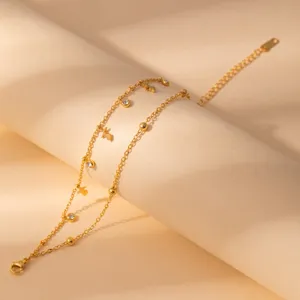 Minimalist stainless steel double-layer gold bracelet with crystal and flower pendants for women.