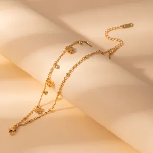 Gold multi-layer chain bracelet featuring clover charms and sparkling rhinestones for elegant styling.