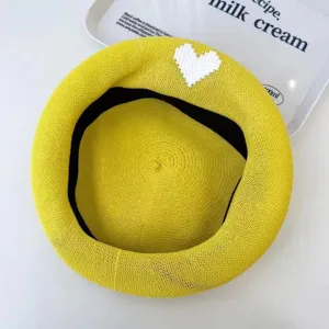 Yellow knitted beret featuring a cute white pixel heart pattern, breathable mesh detail.