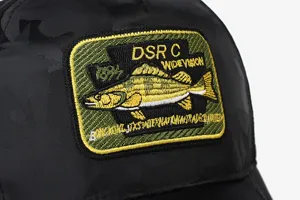 Black camo baseball cap with detailed fish embroidery patch, casual outdoor sun visor.