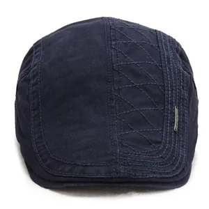 Classic navy blue flat cap for men, stylish stitched pattern and metal badge accent.