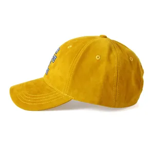 Yellow suede baseball cap featuring detailed blue letter embroidery on the side panel.