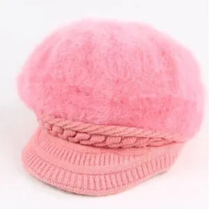 Pink fuzzy knit newsboy hat for women, soft furry winter beret with brim and braided decor.