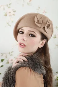 Wool beret detail view, featuring elegant 3D fabric flowers and soft camel fabric texture.