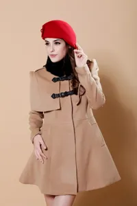 Detailed view of the stylish red wool beret and camel wool coat worn by model.