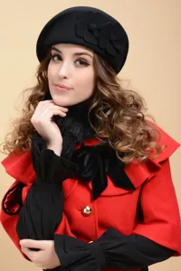 Elegant black wool beret with fabric flower details, perfect for cozy autumn and winter outfits.