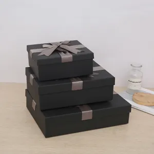 Luxury black rectangular gift boxes featuring elegant grey ribbons, ideal for birthdays.
