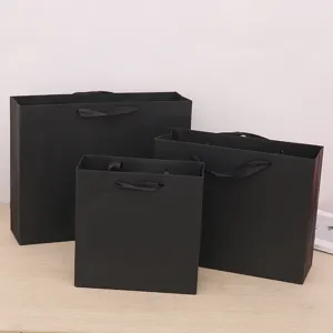Black paper gift bags with black ribbon handles, premium packaging bags for shopping and events.