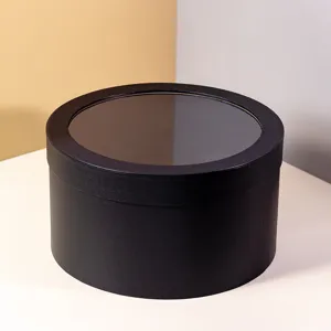 Black round gift box with transparent window for flowers, DIY packaging, presents.