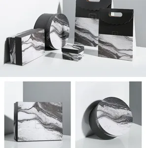 Detailed view of black and white marble texture gift boxes, round boxes, and packaging bags.