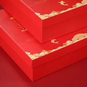 Red festive gift boxes with golden clouds and fish patterns, perfect for packaging special presents.