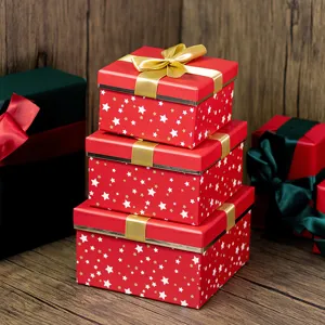 Christmas red gift boxes stack with gold ribbons and star patterns for holiday packaging.