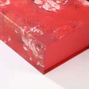 Close-up detail of the elegant red gift box with artistic floral patterns for weddings.