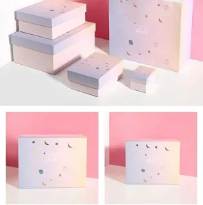 Gradient star moon gift boxes detail view, pastel pink purple paper packaging sets display.